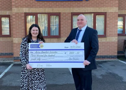 Danaher and Walsh with a donation cheque of £3,500