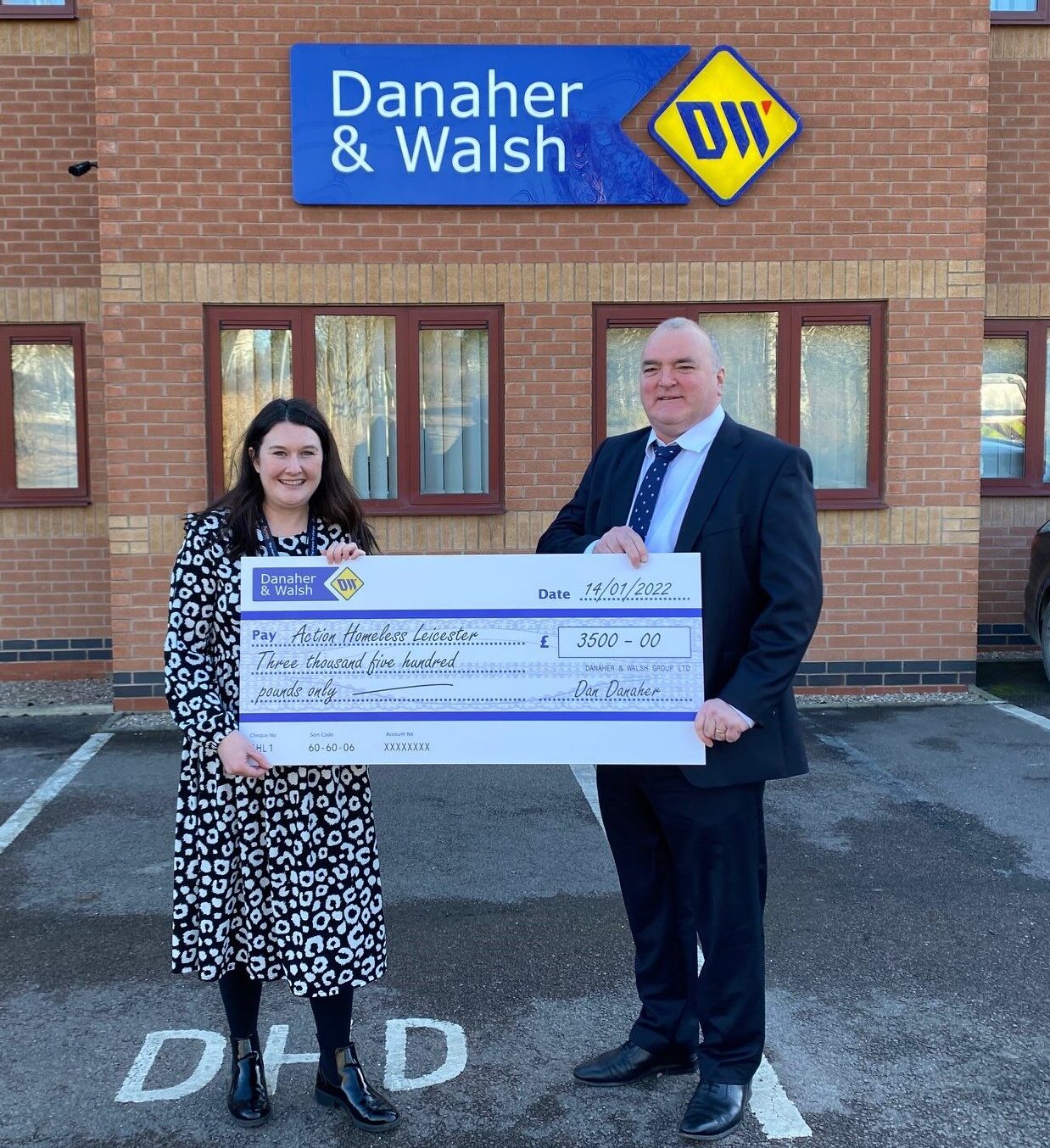 Danaher and Walsh with a donation cheque of £3,500