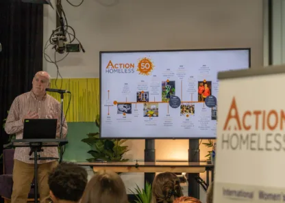 Action homeless staff member giving a presentation.